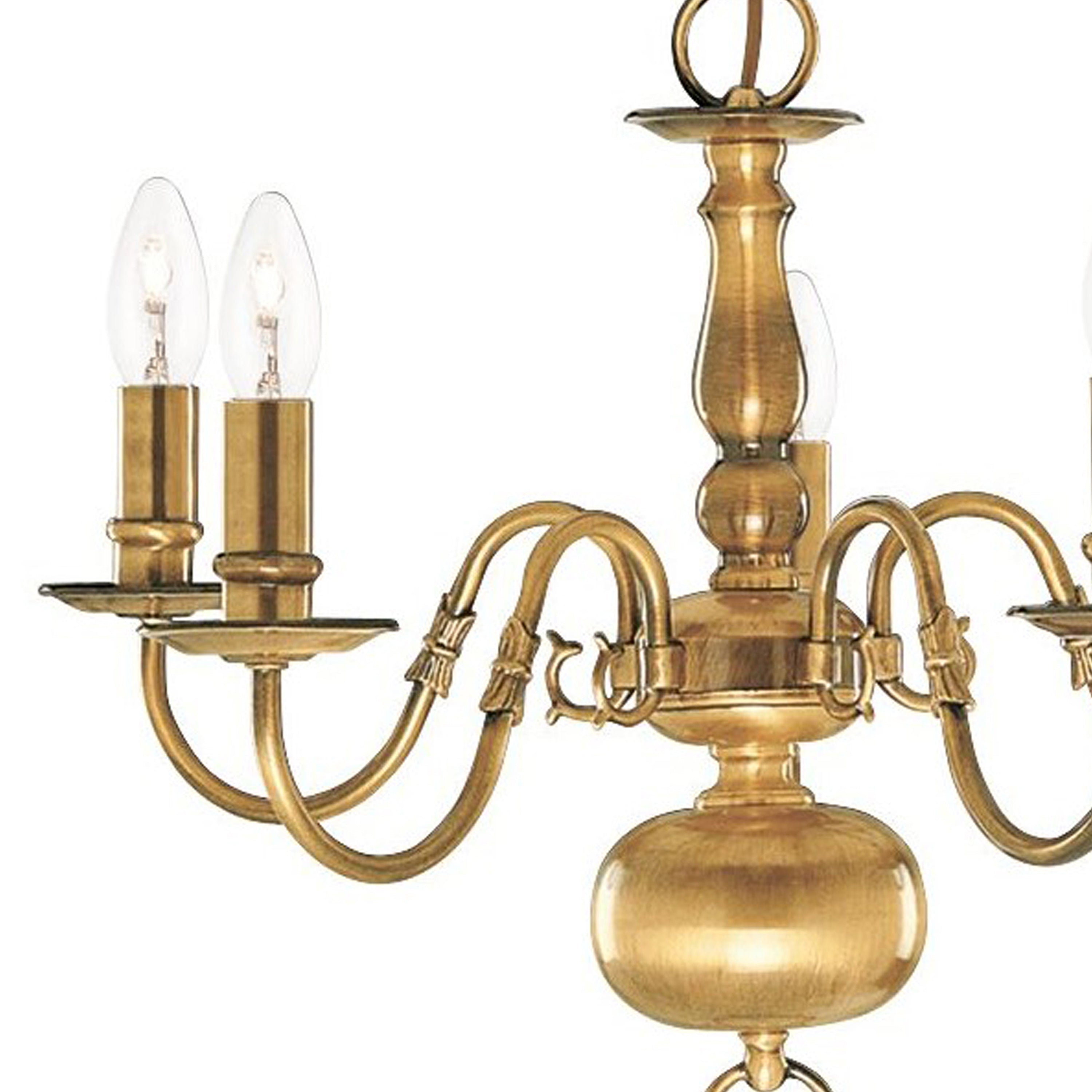 Close-up of a four-arm brass chandelier with candle-style bulbs.