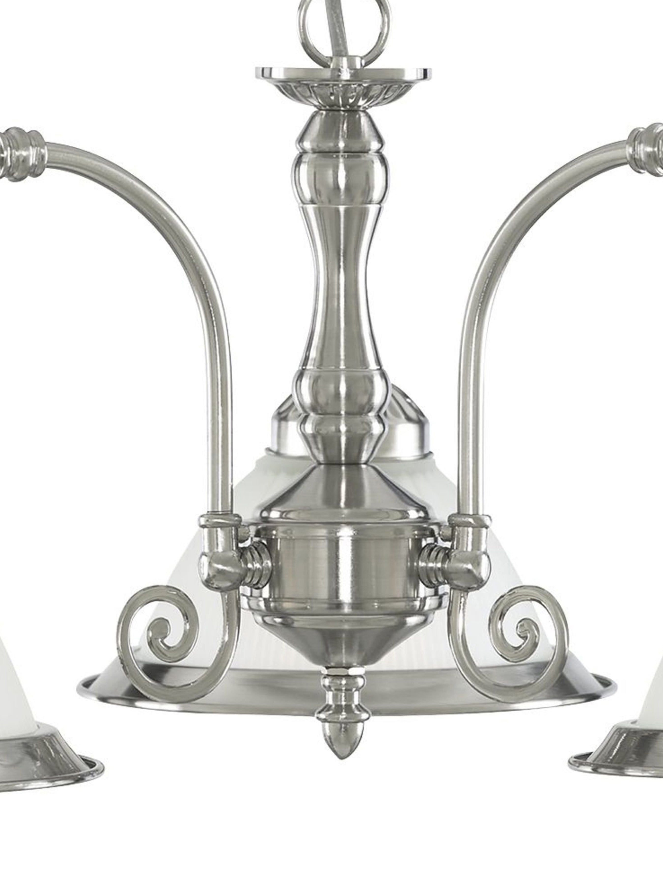 Close-up of a silver chandelier showing decorative details and frosted glass shades.
