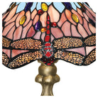 Close-up of the stained glass shade of the Tiffany lamp, showing intricate dragonfly detail.