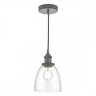 A glass and grey pendant light with a clear bell-shaped shade and an exposed bulb.