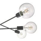 Close-up of clear globe lightbulbs on a black sputnik chandelier.