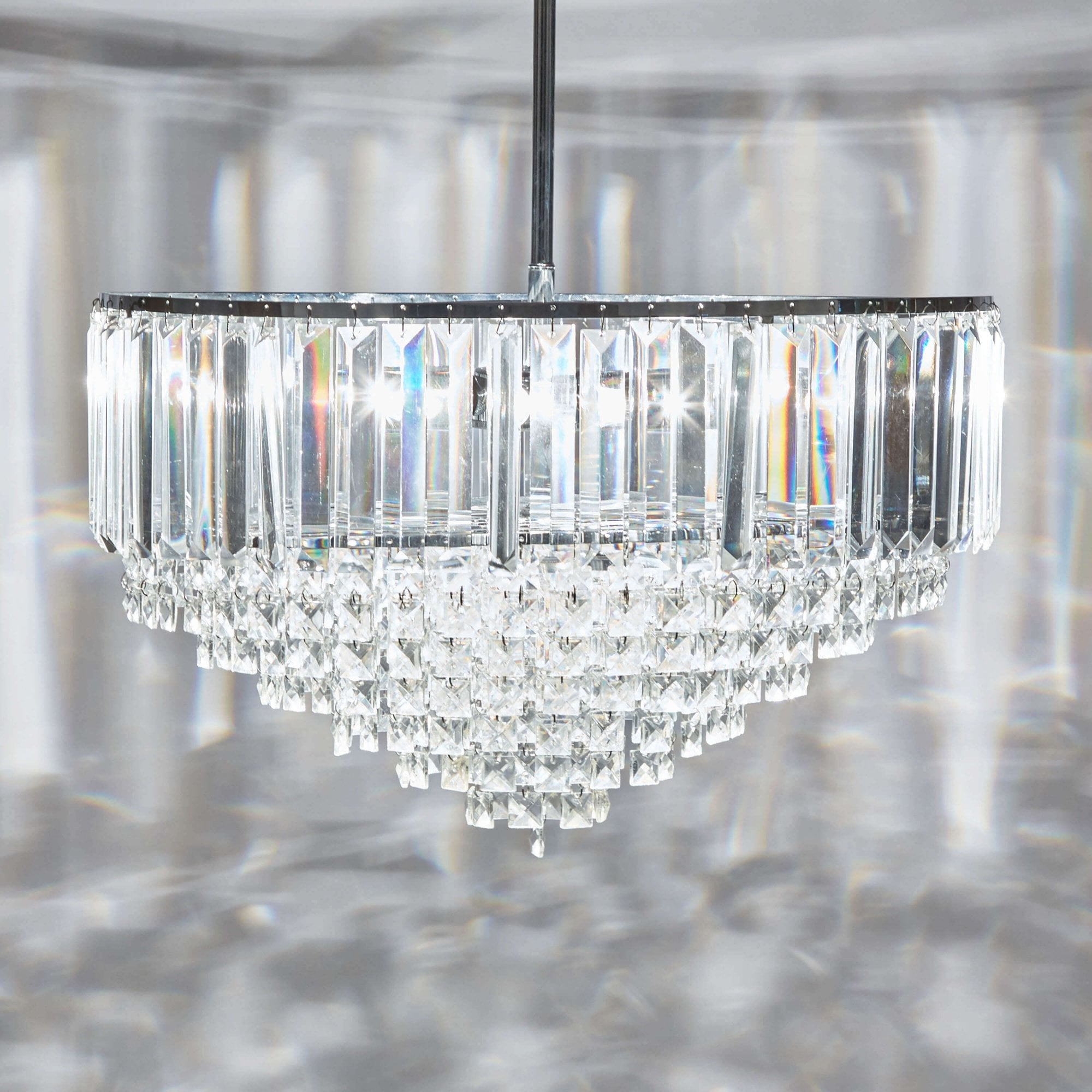 A luxurious crystal chandelier casts sparkling light patterns on the ceiling.