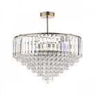 A brilliant tiered crystal chandelier with a brass finish, displayed on a white background.