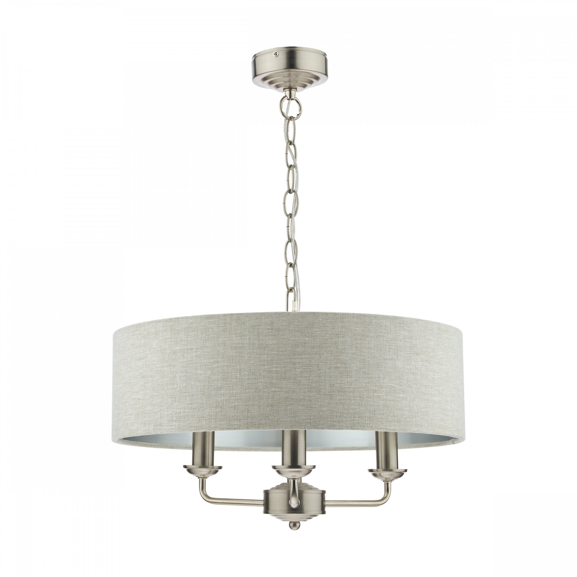 A modern cream fabric drum shade chandelier with three matte silver candle-style lights hangs.