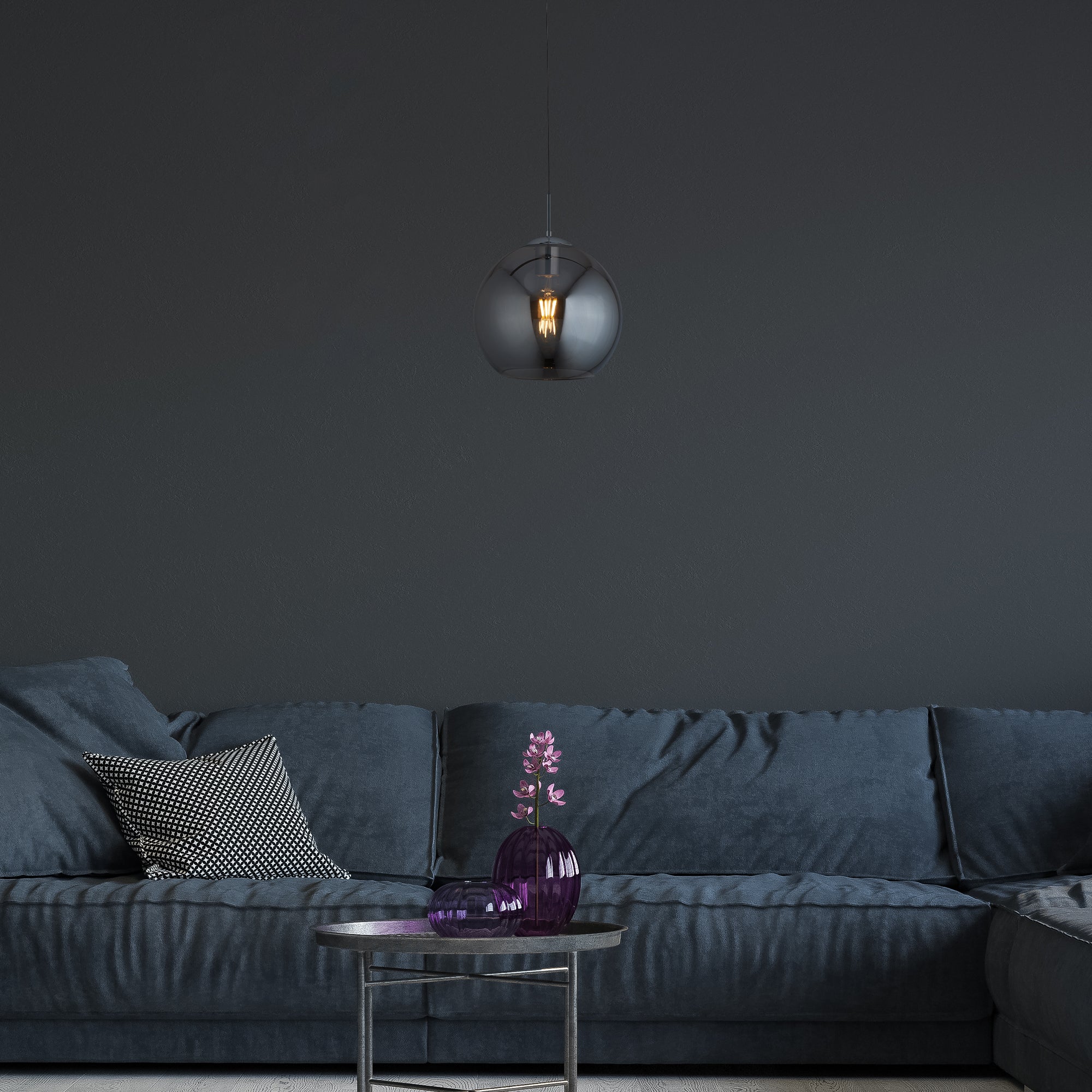 Pendant light hanging above a coffee table in a modern living room setting.