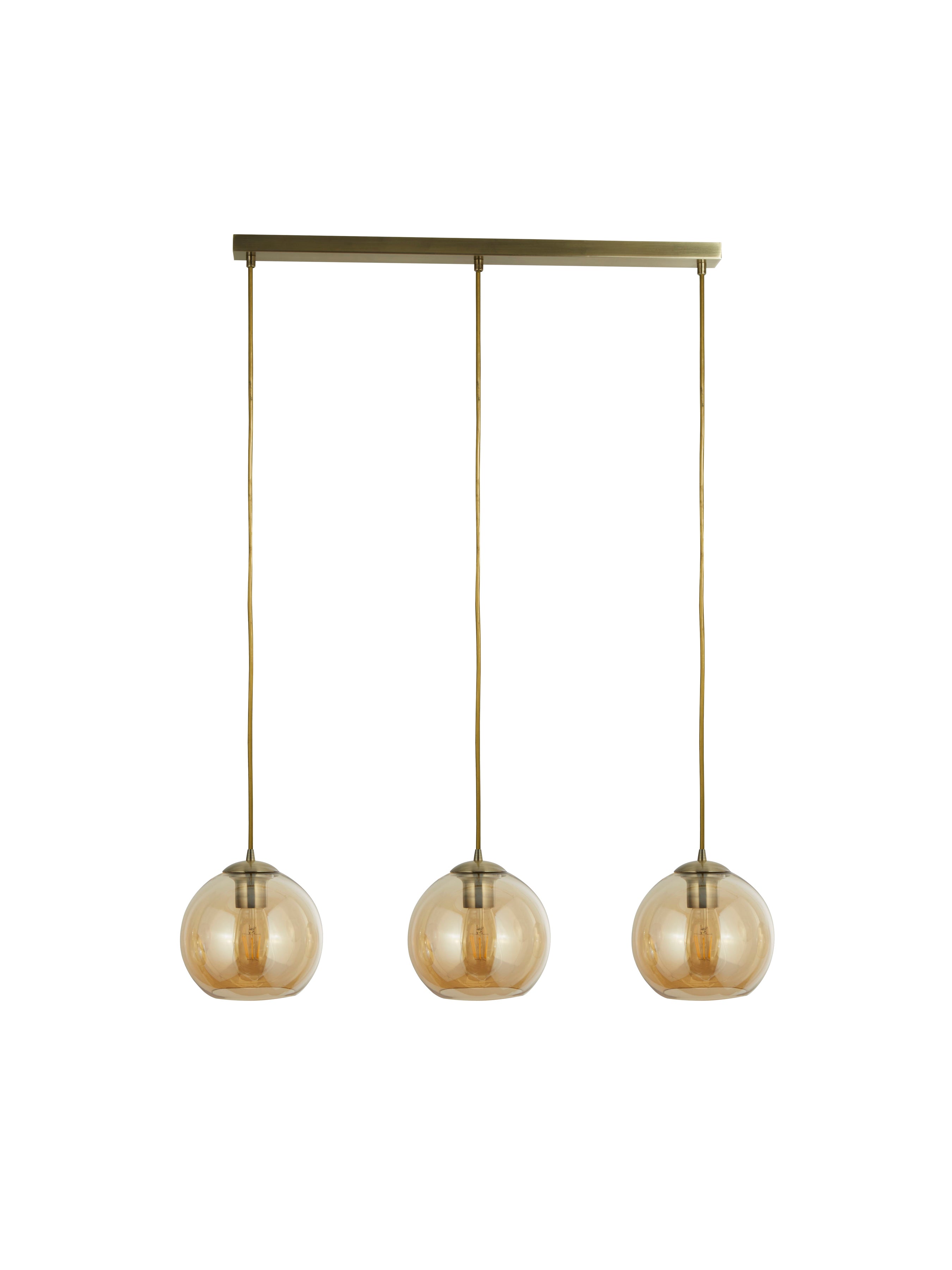 Three amber glass globe pendant lights suspended from a brass bar on a white background.