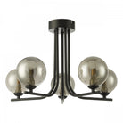 A black ceiling light with five smoked glass globe shades, isolated on a white background.