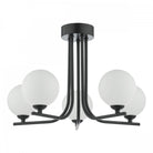 A black ceiling light with five spherical white glass shades on a white background.