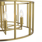Close-up of the brass chandelier showing a detailed view of the exposed light bulbs.