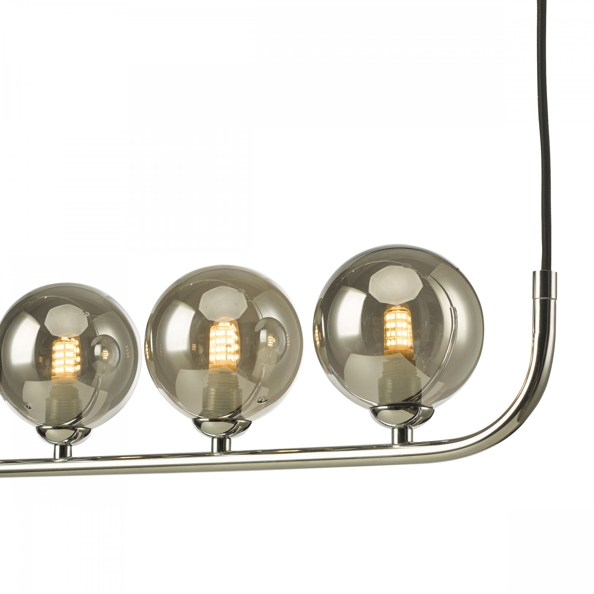 Close-up of three smoky glass globes on a linear pendant light, showcasing the bulb.