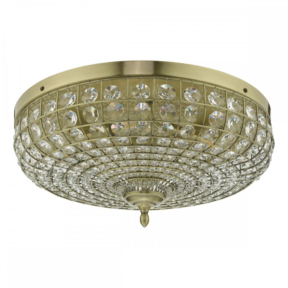 A close up of an ornate crystal-encrusted ceiling light with a gold base.