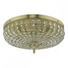 A close up of an ornate crystal-encrusted ceiling light with a gold base.