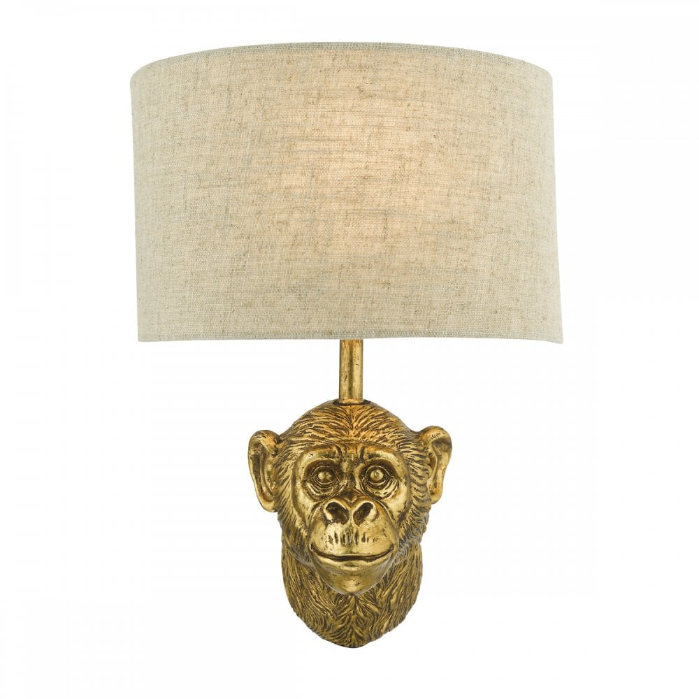 Golden monkey head wall light with a neutral linen shade.