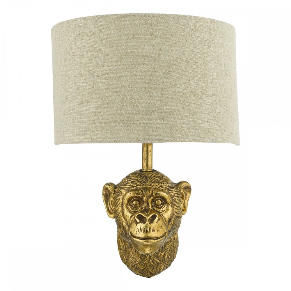 Golden monkey head wall light with a neutral linen shade.