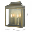 A brass outdoor wall lantern with two lit, candle-style bulbs, with its dimensions noted.