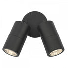 Two black cylindrical spotlights on a round base, emitting a warm white light.