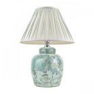 A decorative ginger jar lamp base with a cream pleated lamp shade.