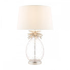 A pineapple-shaped table lamp with a white shade on a white background.
