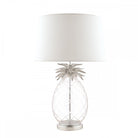 A pineapple-shaped table lamp with a white shade and silver accents.