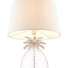Top view of a pineapple table lamp highlighting the white fabric shade and base.