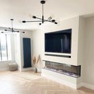 A modern living room with black sputnik chandeliers and a built-in fireplace.