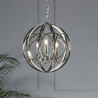 Polished nickel sphere pendant light with three bulbs, a stylish indoor lighting fixture.