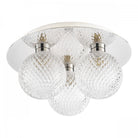 A ceiling light with three textured glass orb shades and a polished chrome base, lit on a white background.