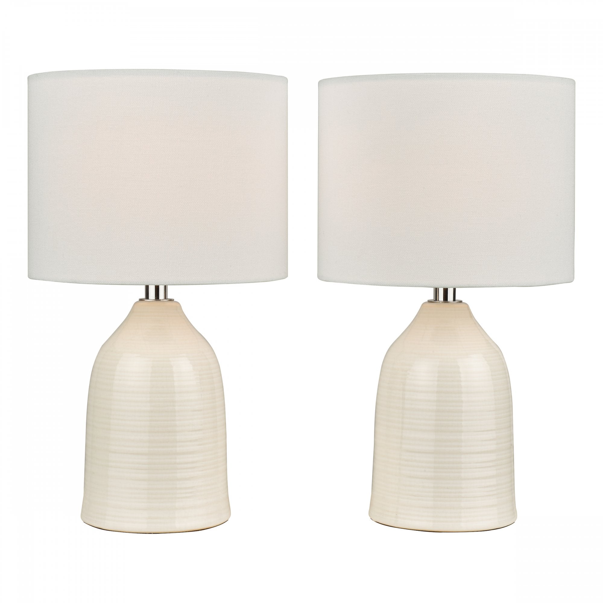 Two white ceramic table lamps with drum shades against a white background.