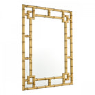 Angled view of a rectangular gold bamboo framed mirror.