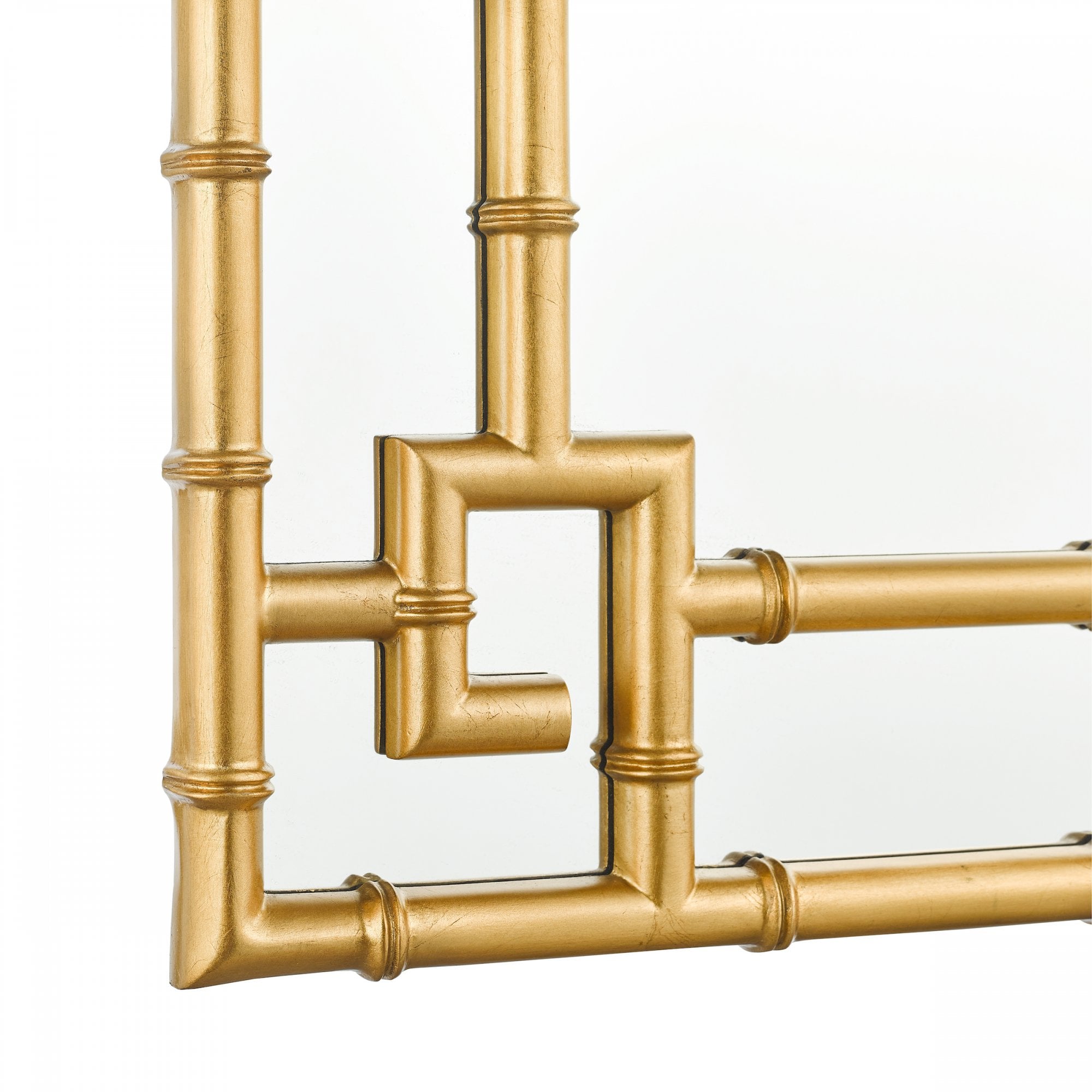 Close-up of the intricate gold bamboo frame detail in the corner of a mirror.
