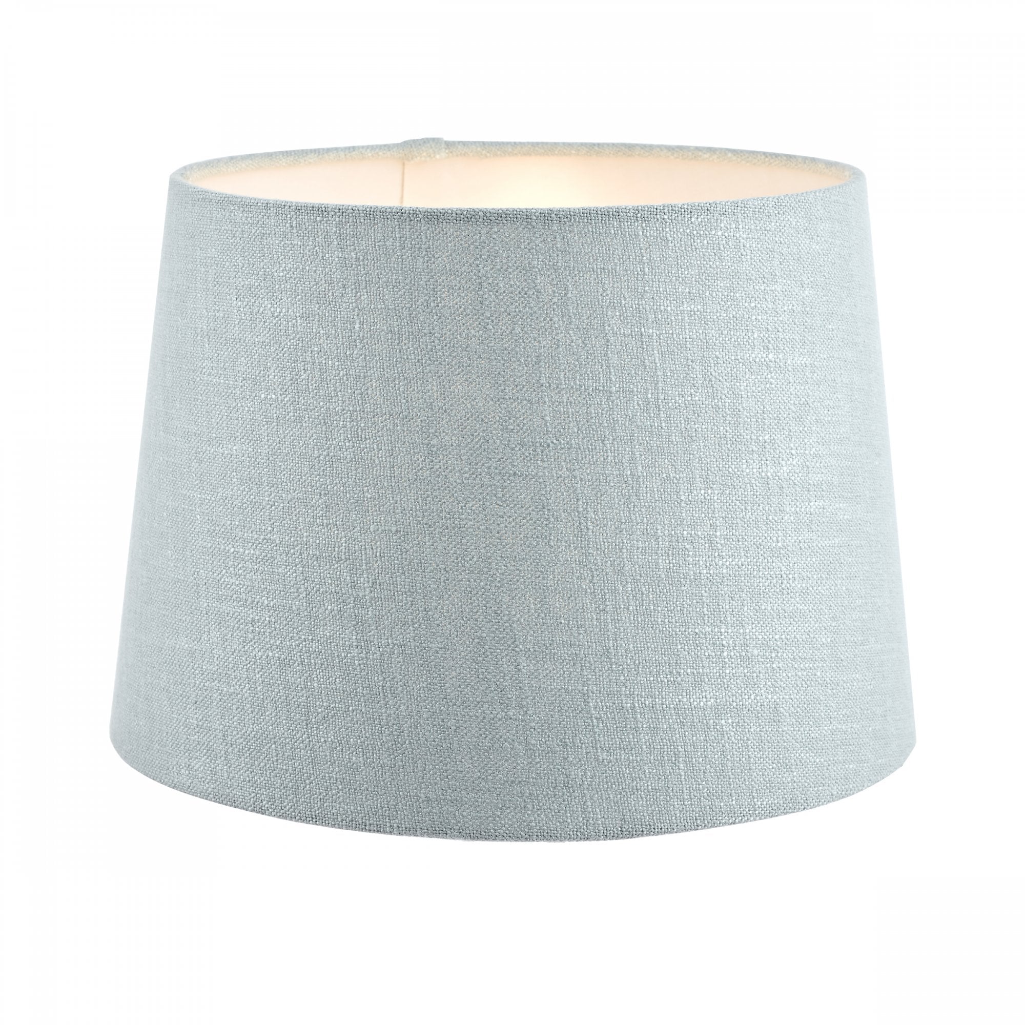 A medium light blue fabric lamp shade with a warm glow from within, for soft illumination.