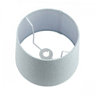 The interior of a medium light blue fabric lamp shade, revealing its sturdy wire frame.