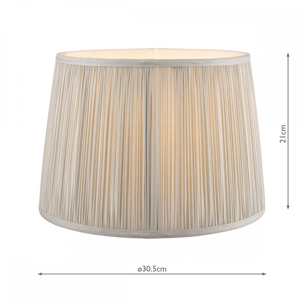 Pleated soft grey lamp shade with light on, showing the internal bulb glow and dimensions.