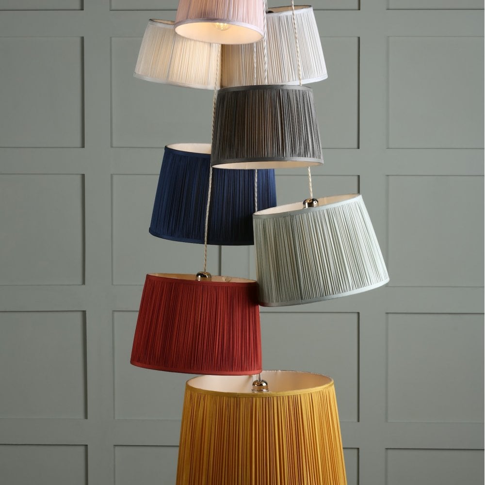 A stack of colorful pleated lampshades.