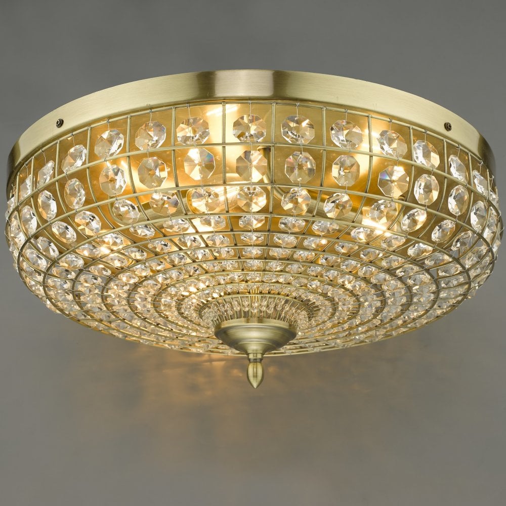 An ornate crystal-encrusted ceiling light with a gold base.