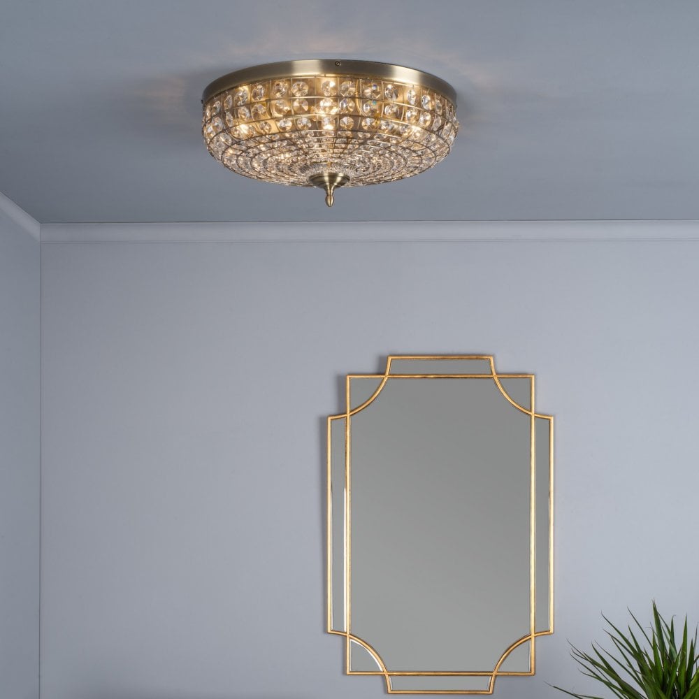 A close up of a beautiful crystal flush light.