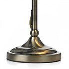 Close-up of the antique brass base of the table lamp.