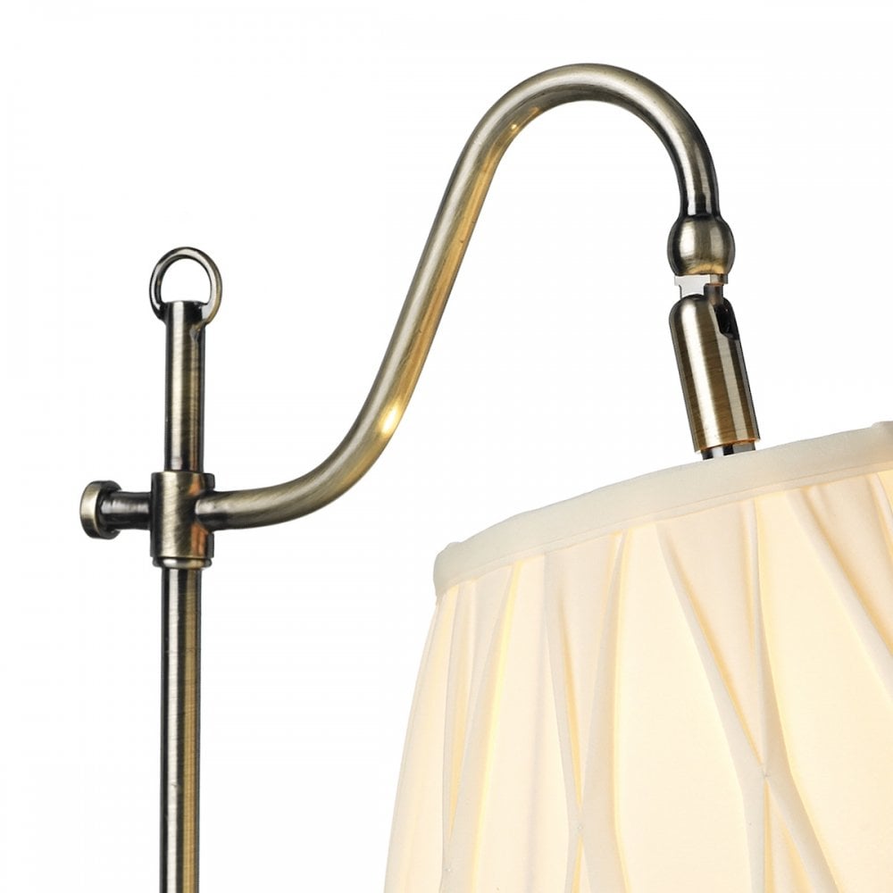 Close-up of the antique brass adjustable arm of the table lamp.