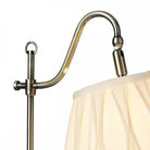 Close-up of the antique brass adjustable arm of the table lamp.