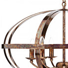 Detail of the chandelier's distressed metal frame and candle-style bulbs.