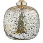 Close-up of the textured, speckled silver mercury glass base of a table lamp.