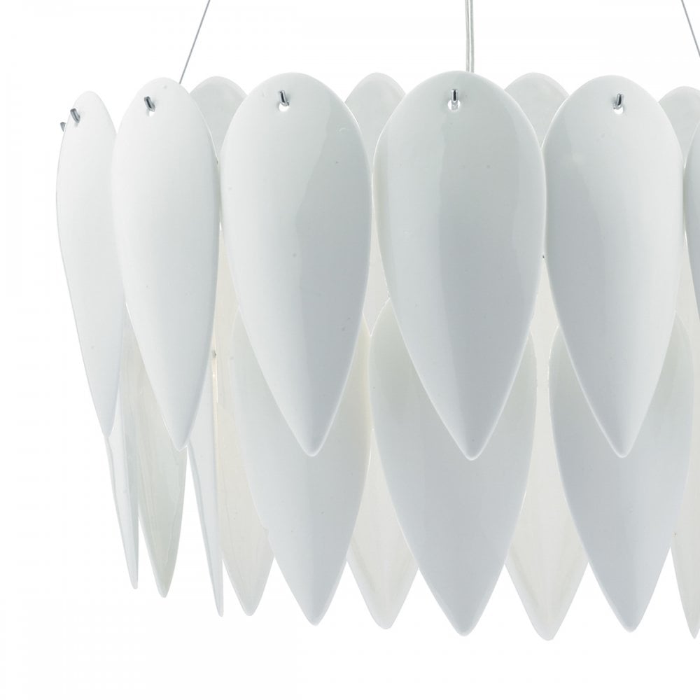 A close-up of the white, layered petal-like shades of a decorative pendant light fixture.