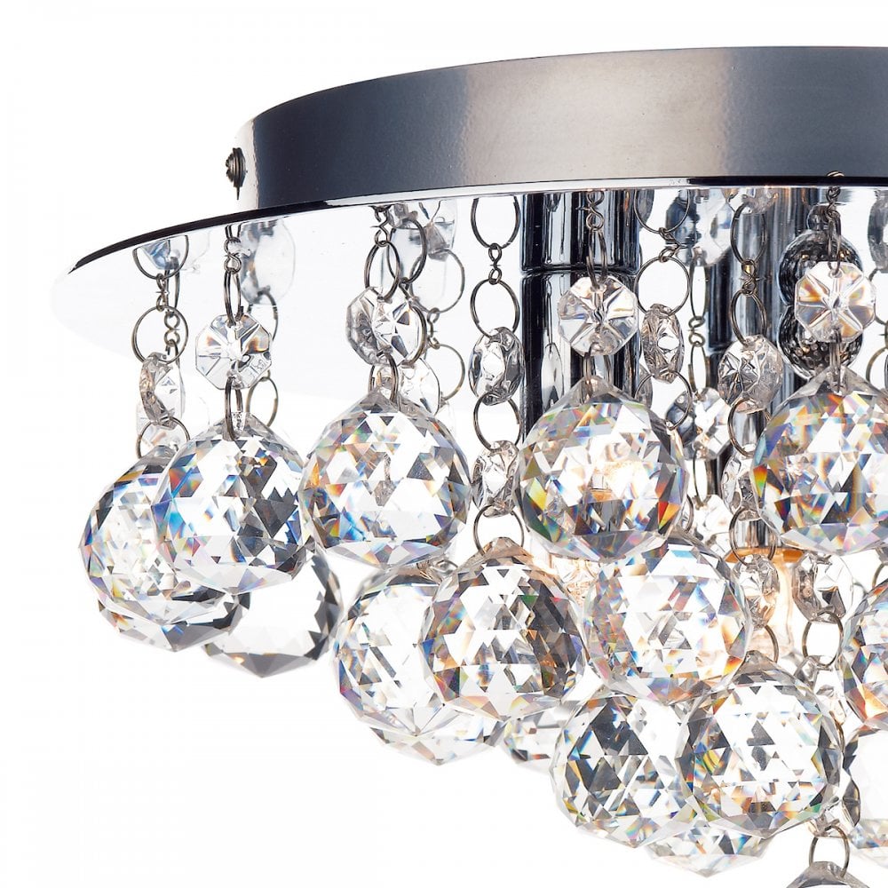 A close-up view of the crystal ceiling light highlighting the crystal balls and chains.