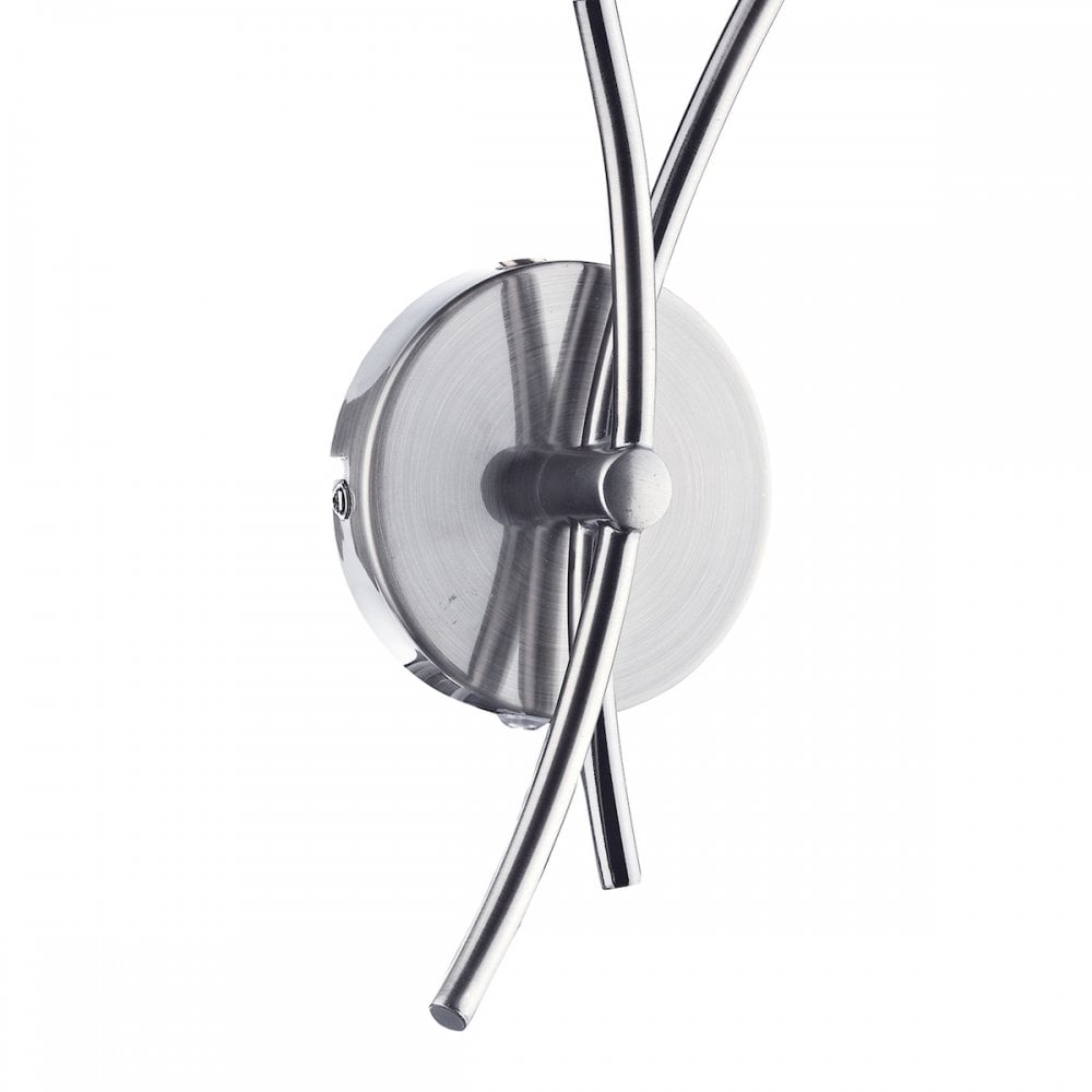 Close-up of the chrome base and curved arms of the wall light.