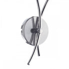 Close-up of the chrome base and curved arms of the wall light.