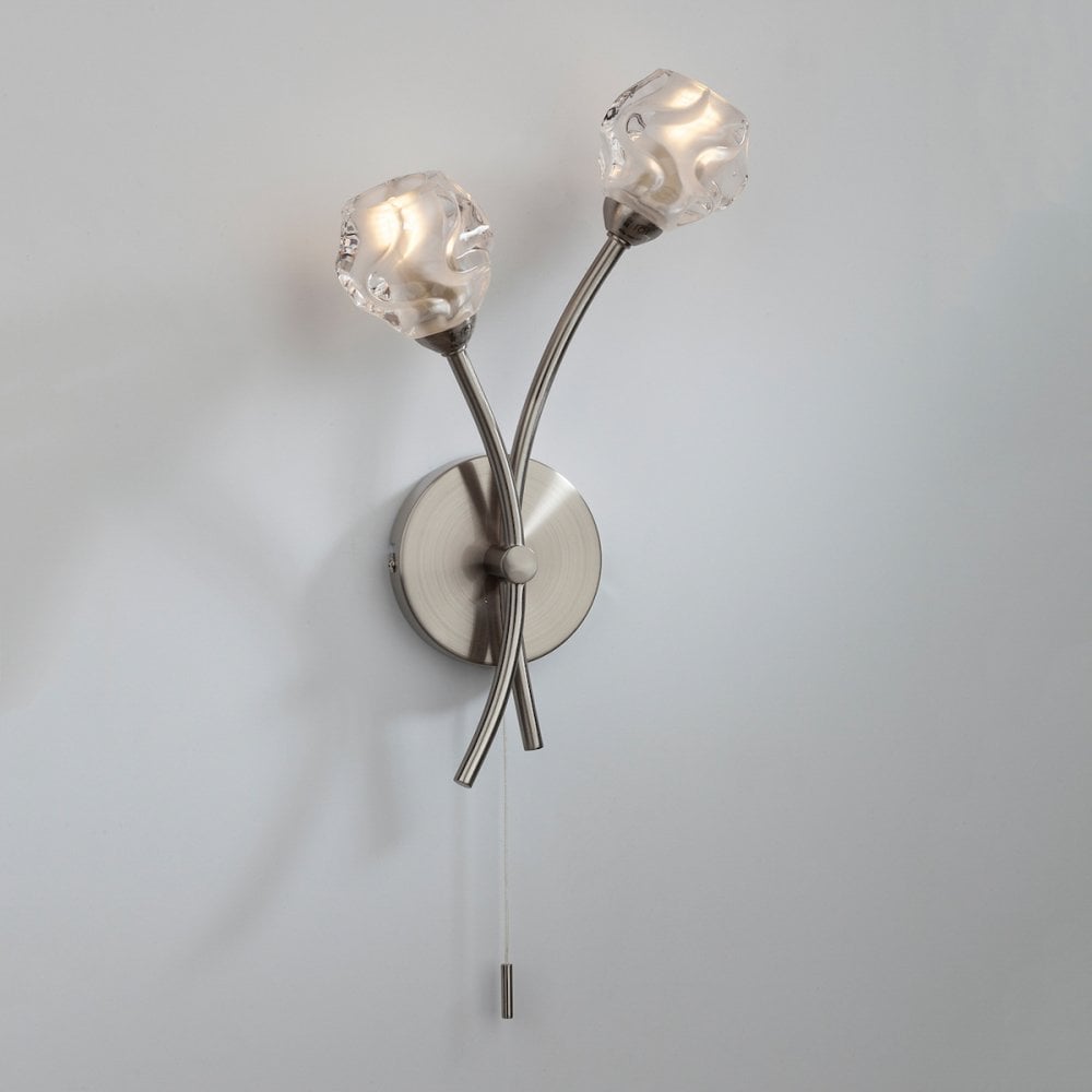 Brushed chrome wall light with two glass shades and a pull cord switch.