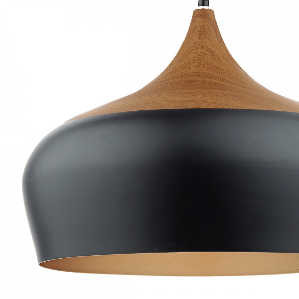 Close-up of black and wood pendant light with gold interior.