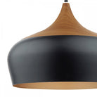 Close-up of black and wood pendant light with gold interior.