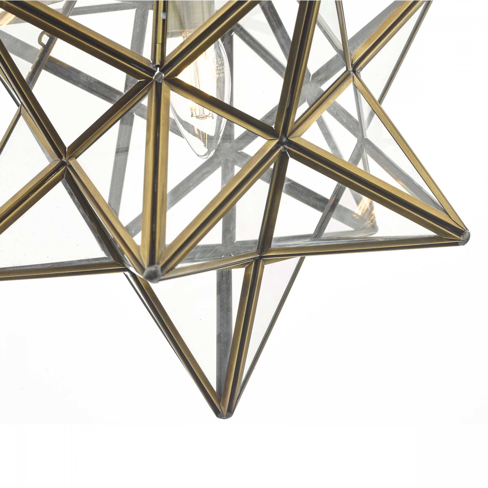 Close-up of the star-shaped pendant light, showing the intricate glass and brass frame.