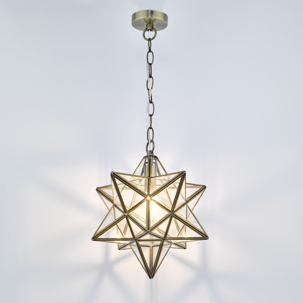 The star-shaped pendant light illuminated, casting star-like shadows on the wall.